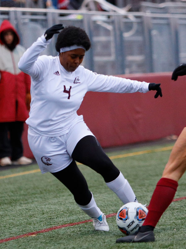 Olivia House moving the ball on the soccer field during a game