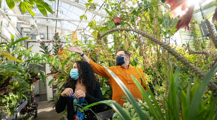 Assistant Professor Leon Van Eck and student worker Caityana Hanson ’22 browse the greenhouse.