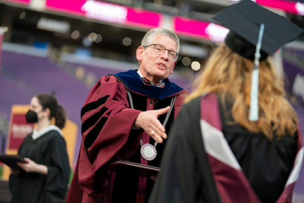 President Pribbenow shaking a student's hand