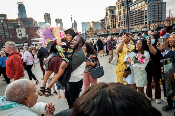 Students celebrating graduating with family and friends