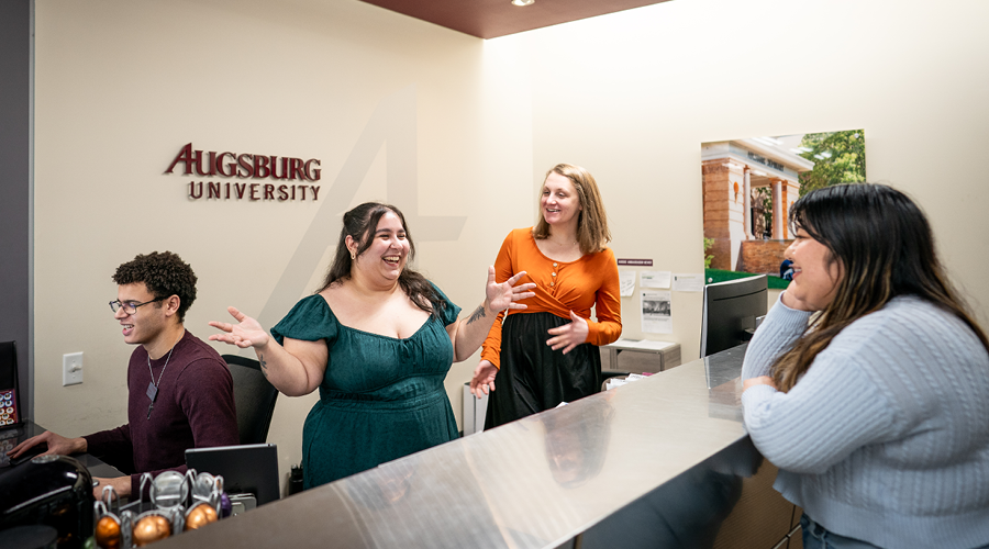 Admissions staff, Anna Cox ’22 and Stephanie Ruckel, talk with student, Elsy Cruz Parra ’26 in the Augsburg Admissions office. (Photo by Courtney Perry)