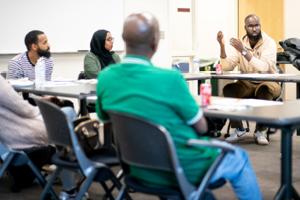 <strong>Abdi</strong> talks with fellow EAST members during a meeting, 2022. (Photo by Courtney Perry)