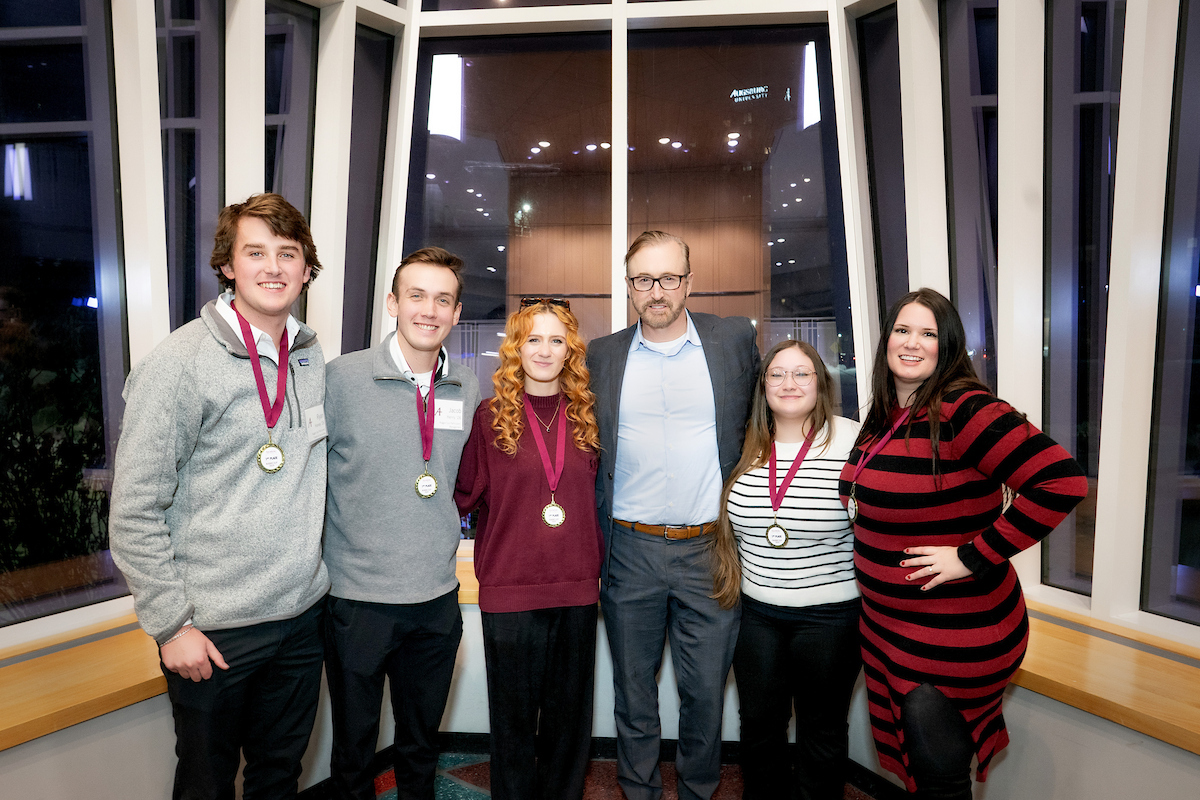The five student winners of the 3rd Annual Auggie Cup pose in the lobby of Hagfors Center with David Perdue, founder of Navatar Health.