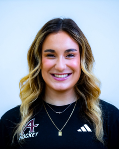 Headshot of Elizabeth Bauer, women's hockey coach, smiling in an Augsburg hockey shirt.