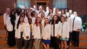 Students wearing white coats 