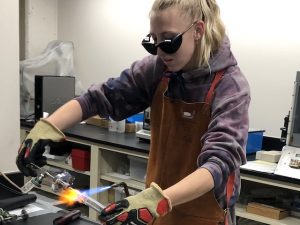 Jade Boysen sealing a quartz tube with a blowtorch