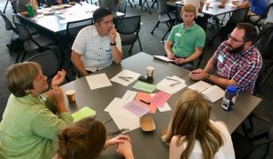team of people gathered around a table