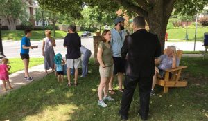 people talk in groups outside