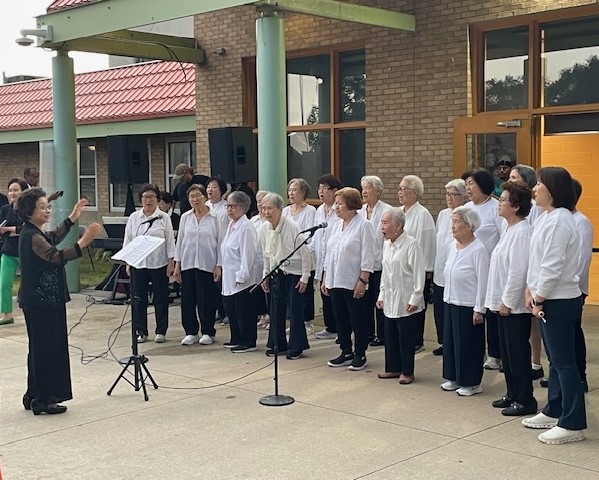 Korean Elders Choir performs in front of the Brian Coycle Center at the Annual Cedar Riverside Multicultural Dinner