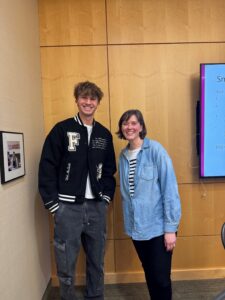 Two people standing next to each other smiling