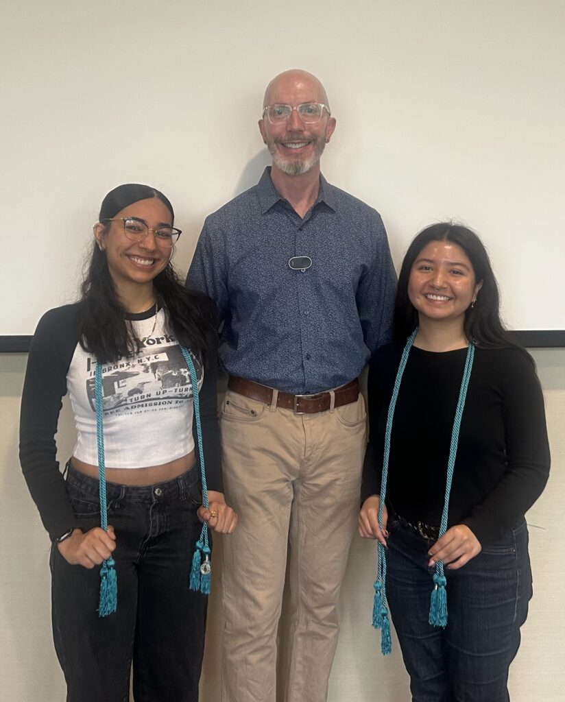 Alexa De Leon and Veronica Arellano Martinez pose with Prof. James Vela-McConnell, their departmental honors faculty mentor.