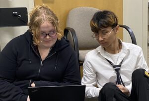 Picture of Emelia Koehler '27 and Moo May Wah '26 using a laptop to study.