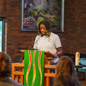 A woman stands confidently at a podium